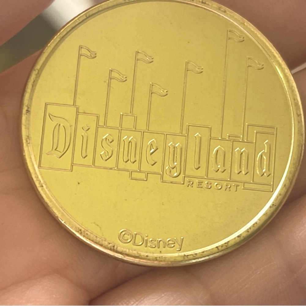 Disneyland magic key golden medallion Disneyland sign